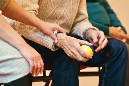 old person holding ball